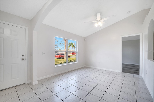 tiled empty room with vaulted ceiling and ceiling fan