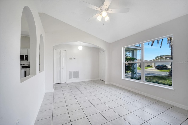 empty room with light tile patterned floors, ceiling fan, and lofted ceiling