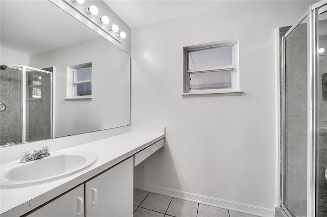 bathroom with tile patterned flooring, vanity, and walk in shower