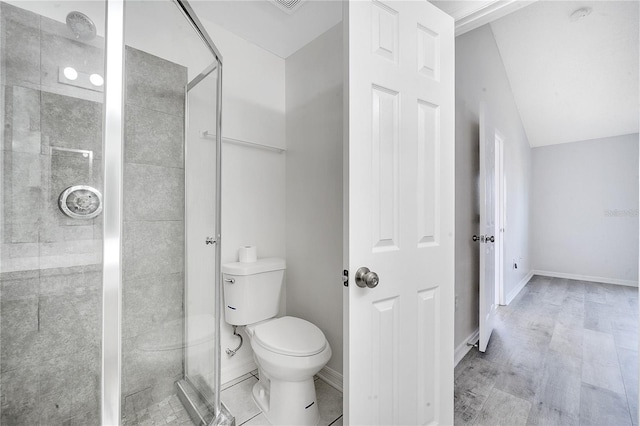 bathroom featuring toilet and walk in shower