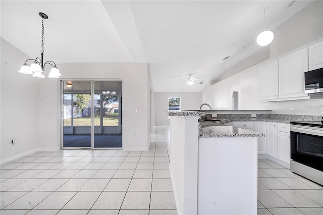 kitchen featuring white cabinets, ceiling fan with notable chandelier, vaulted ceiling, light tile patterned floors, and appliances with stainless steel finishes