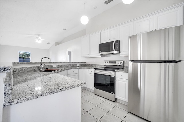 kitchen with white cabinets, vaulted ceiling, ceiling fan, kitchen peninsula, and stainless steel appliances