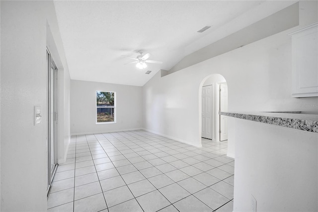 tiled spare room featuring ceiling fan and lofted ceiling