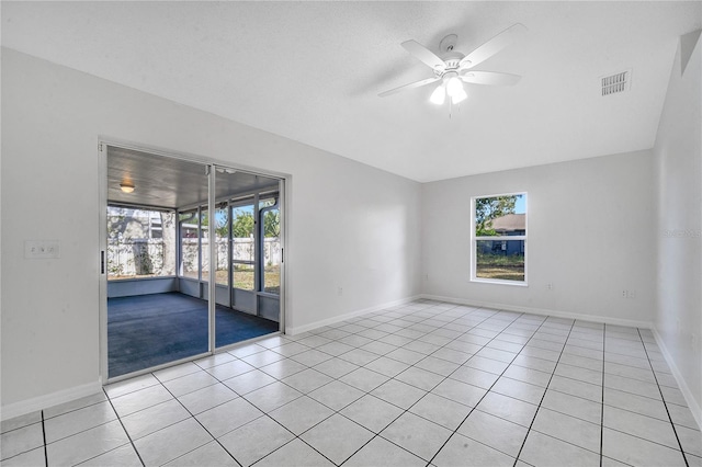 spare room featuring ceiling fan and light tile patterned floors