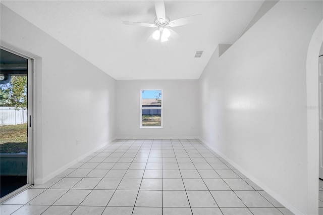 tiled empty room featuring ceiling fan and lofted ceiling