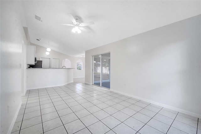 unfurnished room featuring light tile patterned floors, vaulted ceiling, and ceiling fan