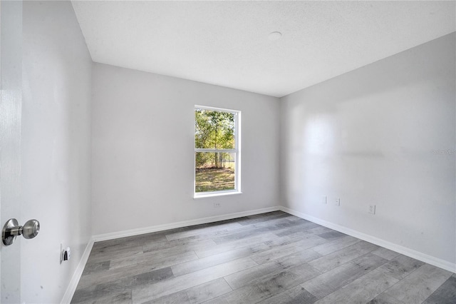 empty room with wood-type flooring