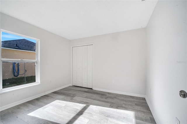 empty room with light hardwood / wood-style flooring