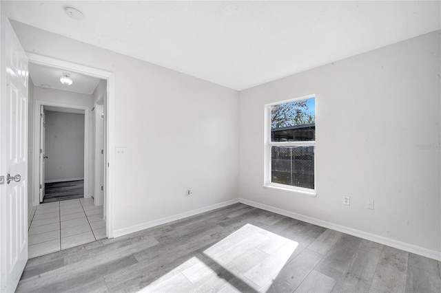 unfurnished room with light wood-type flooring