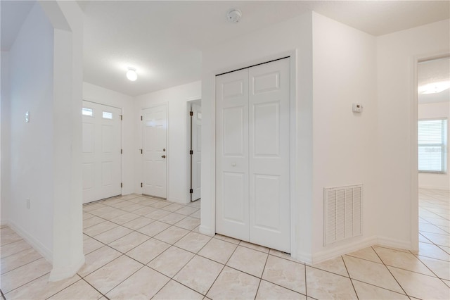 foyer entrance with light tile patterned flooring