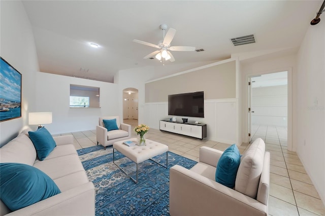 tiled living room featuring ceiling fan and lofted ceiling