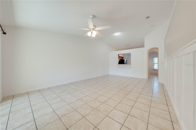 tiled empty room featuring ceiling fan