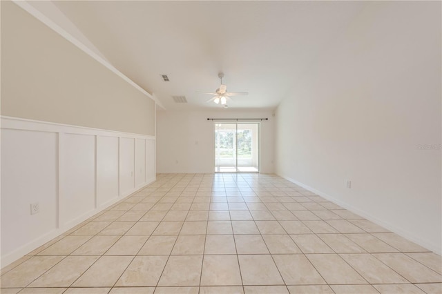 spare room featuring light tile patterned floors, ceiling fan, and ornamental molding