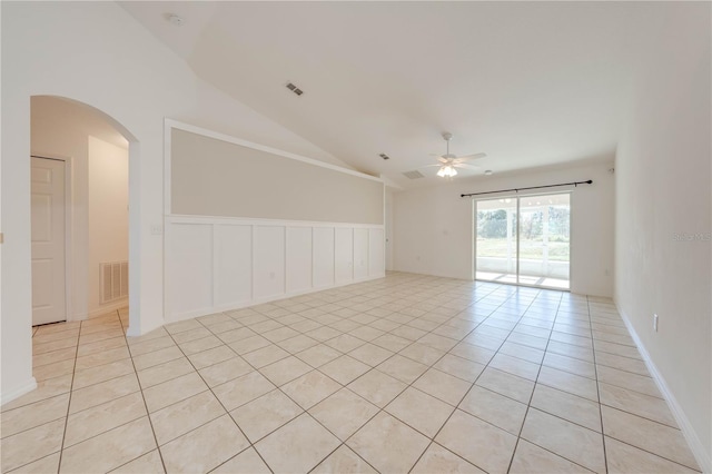 tiled spare room featuring ceiling fan and vaulted ceiling