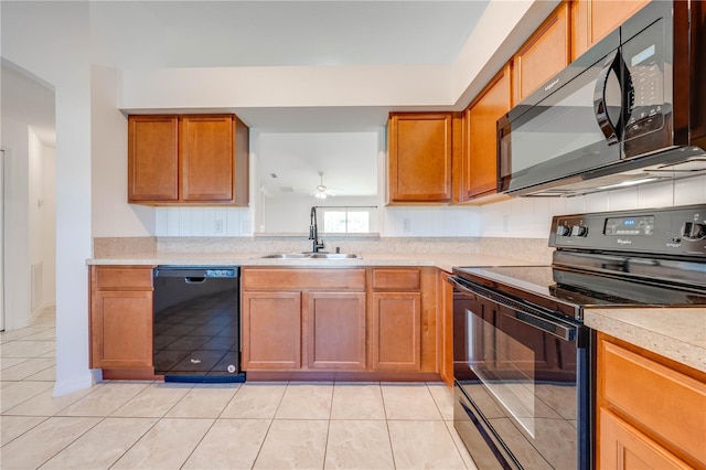 kitchen featuring light tile patterned floors, sink, ceiling fan, and black appliances