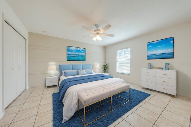 bedroom with a closet, ceiling fan, and light tile patterned flooring