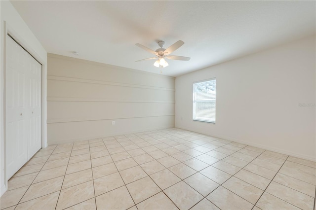 unfurnished room featuring ceiling fan and light tile patterned flooring