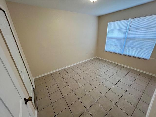 unfurnished room with light tile patterned floors