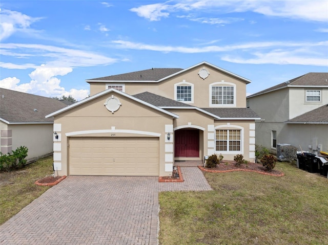 view of property featuring a front yard and a garage