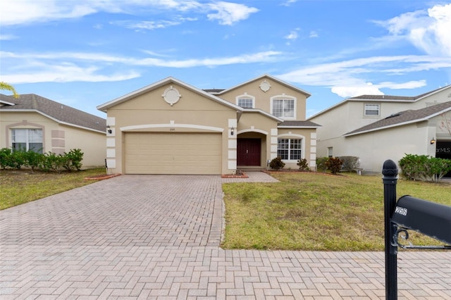 256 Lancaster Dr, Davenport, FL 33897 - traditional-style home with decorative driveway, stucco siding, a garage, and a front lawn