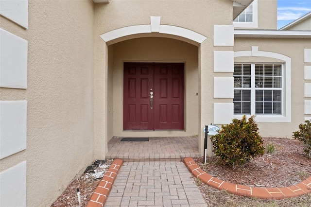 256 Lancaster Dr, Davenport, FL 33897 - doorway to property featuring stucco siding