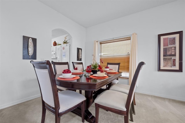 dining area with light colored carpet