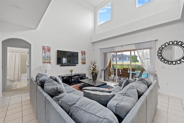 256 Lancaster Dr, Davenport, FL 33897 - living area featuring light tile patterned floors, a towering ceiling, and plenty of natural light