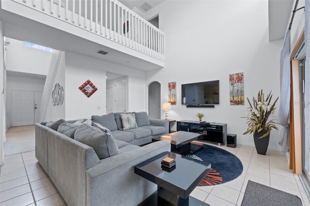 256 Lancaster Dr, Davenport, FL 33897 - living area with arched walkways, a towering ceiling, and light tile patterned flooring