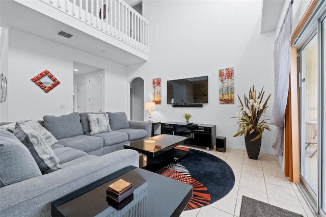 256 Lancaster Dr, Davenport, FL 33897 - living area featuring arched walkways, a high ceiling, and light tile patterned floors
