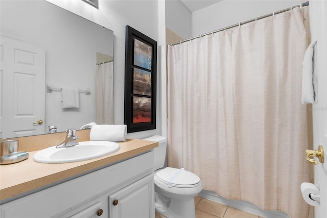 bathroom featuring tile patterned flooring, vanity, toilet, and walk in shower