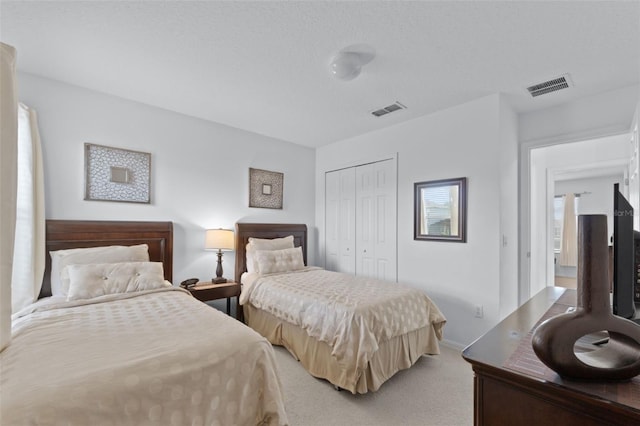 carpeted bedroom with a closet