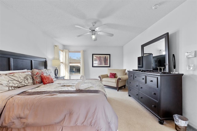 carpeted bedroom with a textured ceiling and ceiling fan