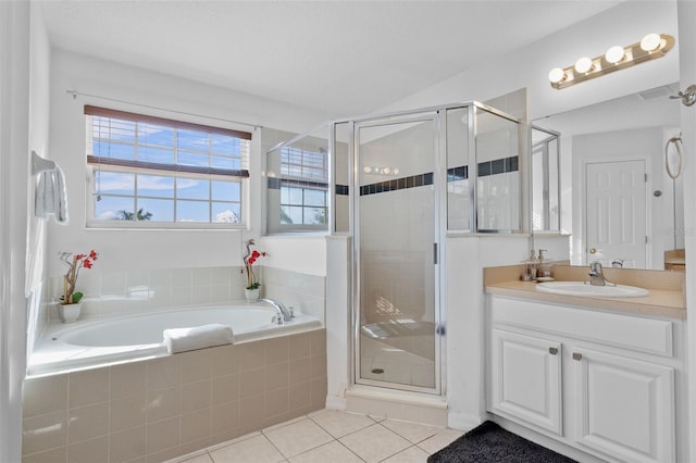 256 Lancaster Dr, Davenport, FL 33897 - bathroom with tile patterned floors, vanity, a garden tub, and a stall shower