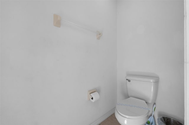 bathroom with toilet and tile patterned floors