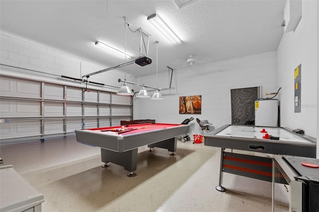 game room featuring water heater, a textured ceiling, and pool table