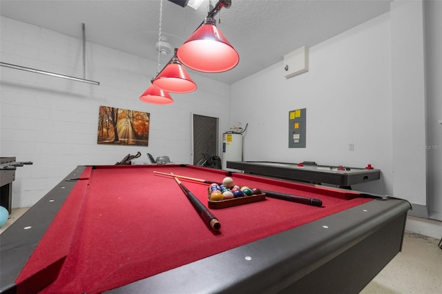 game room with electric panel, a textured ceiling, pool table, and water heater