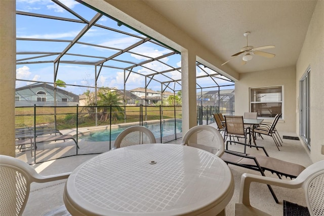 256 Lancaster Dr, Davenport, FL 33897 - view of patio / terrace with outdoor dining area, ceiling fan, an outdoor pool, glass enclosure, and a residential view