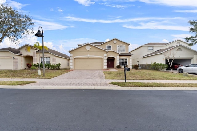 256 Lancaster Dr, Davenport, FL 33897 - traditional-style home with decorative driveway, stucco siding, a garage, and a front lawn