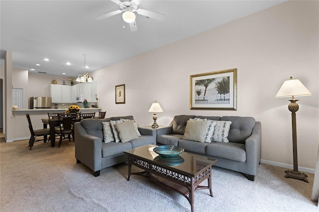 carpeted living room with ceiling fan