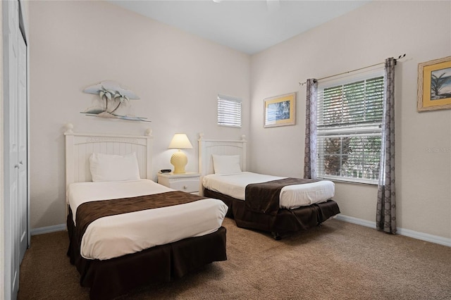 carpeted bedroom with ceiling fan and a closet