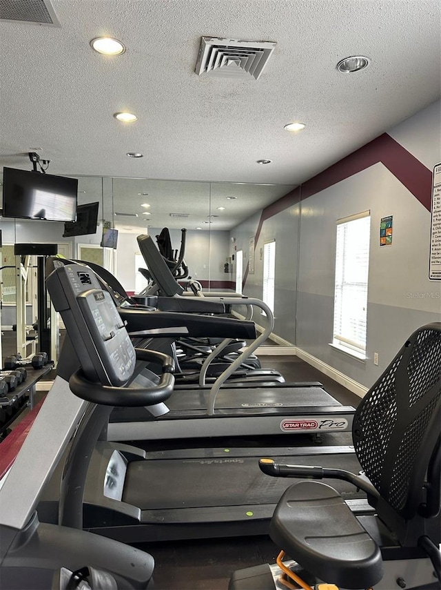 gym featuring a textured ceiling