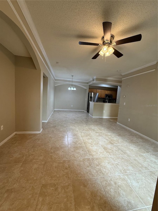 unfurnished living room with ornamental molding, light tile patterned flooring, ceiling fan with notable chandelier, and a textured ceiling