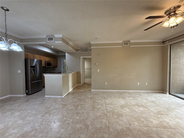 kitchen with decorative light fixtures, ornamental molding, kitchen peninsula, ceiling fan with notable chandelier, and appliances with stainless steel finishes