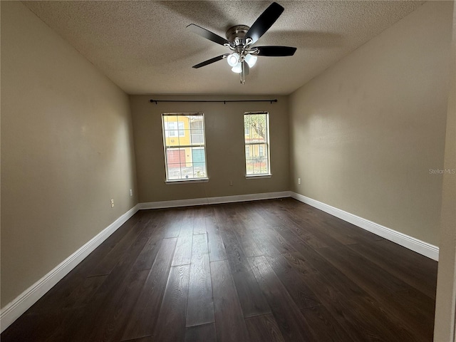 unfurnished room with ceiling fan, dark hardwood / wood-style flooring, and a textured ceiling