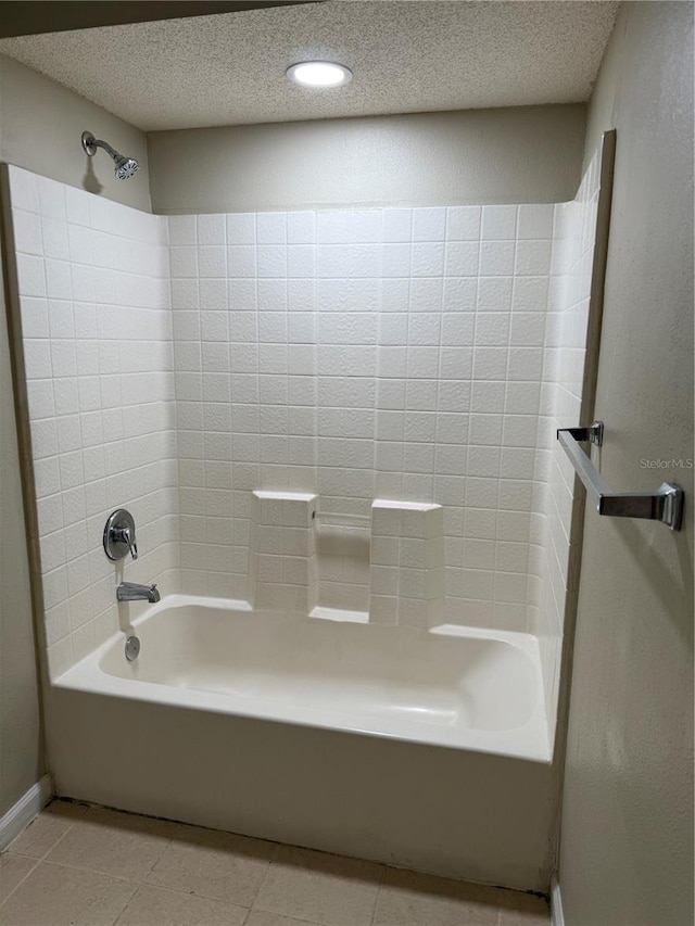 bathroom featuring tile patterned flooring, a textured ceiling, and shower / tub combination