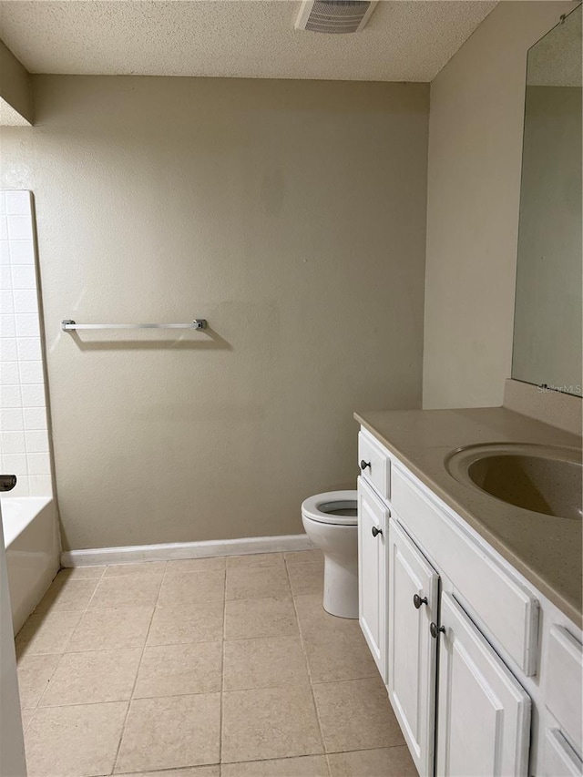 bathroom featuring toilet, a textured ceiling, tile patterned floors, and vanity