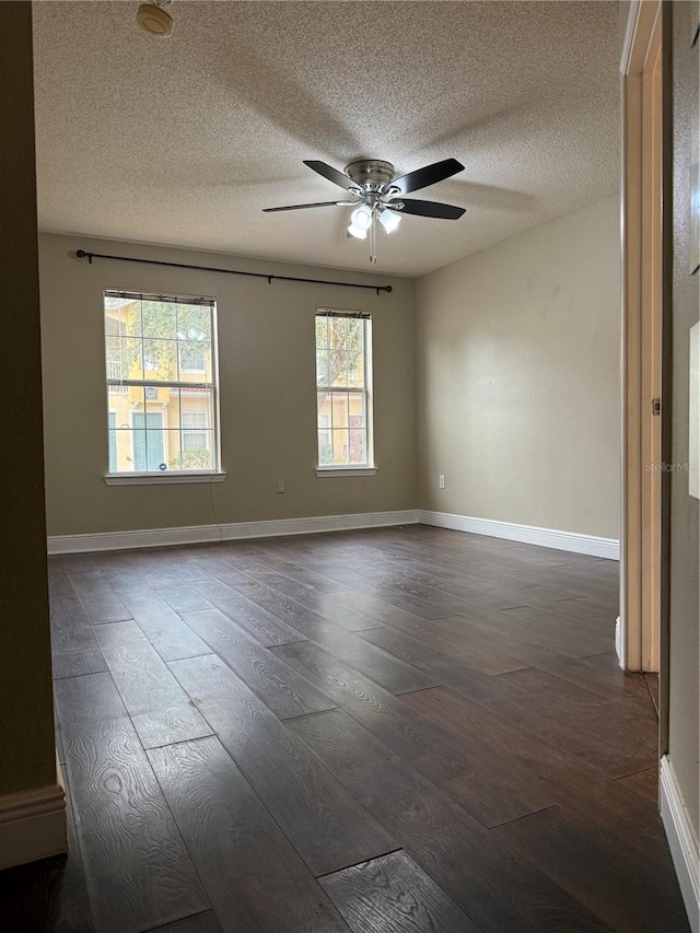 unfurnished room featuring ceiling fan, a textured ceiling, and dark hardwood / wood-style floors