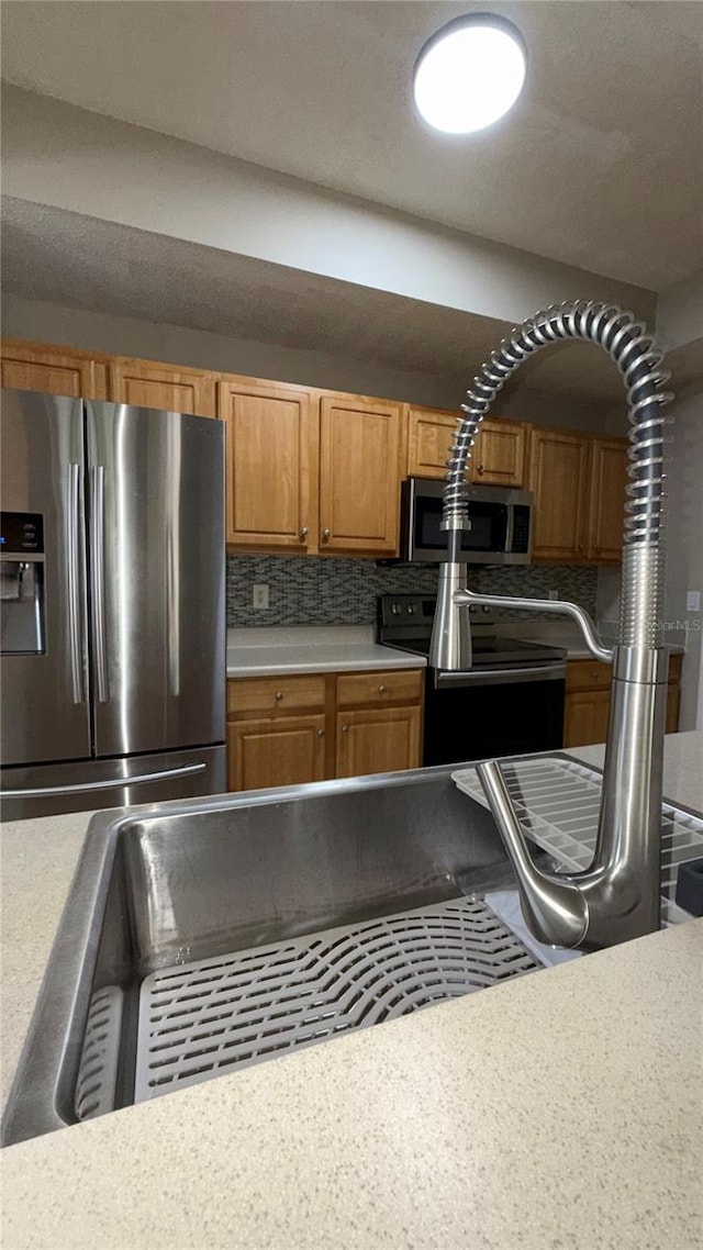 kitchen featuring stainless steel appliances and decorative backsplash