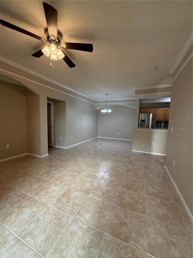 empty room featuring ceiling fan with notable chandelier, a textured ceiling, and crown molding