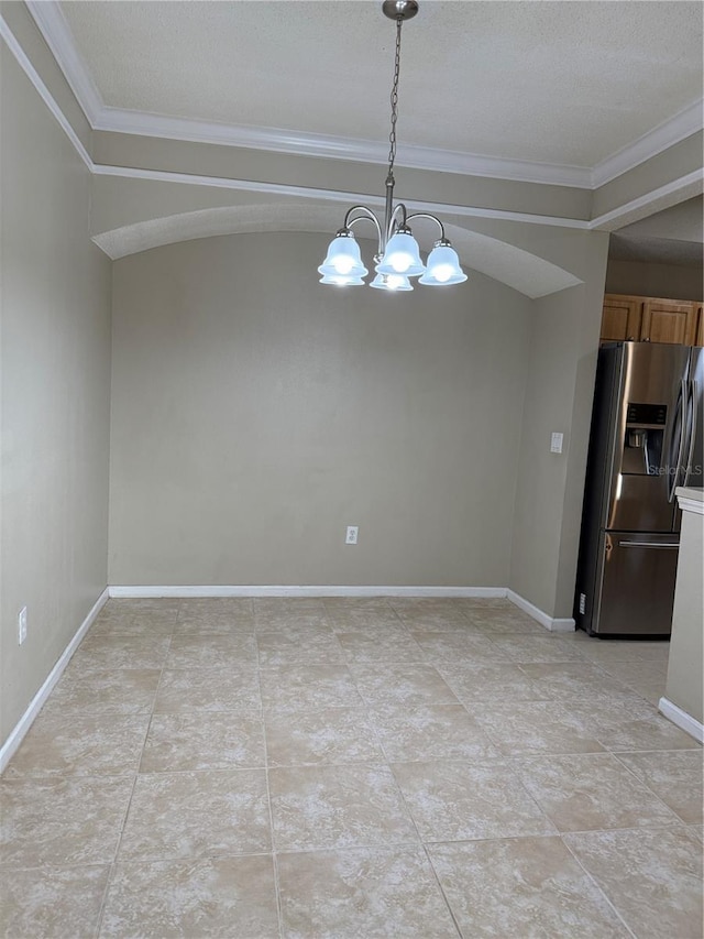 unfurnished dining area with a textured ceiling, crown molding, and a chandelier